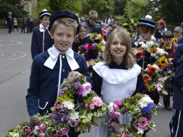 Bisley Well Dressing Children Carrying Star Shaped Floral Arrangements Head the Procession of Flowers in the Cotswolds